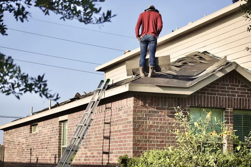 Professional roofer working on a residential roof in Tieton